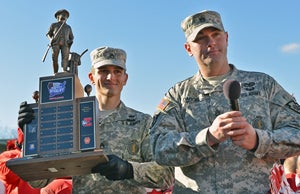 Sergeant Darios of the Pennyslvannia Army National
Guard presents the Rivalry Series trophy to the
team and the entire Rover nation after their
victory on Thanksgiving Day.