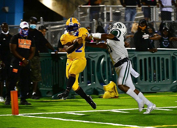 Northwestern running back Saddiq Jackson stiff-arms his way into the end zone in the Bulls' 21-14 win Friday over No. 10 Miami Central.