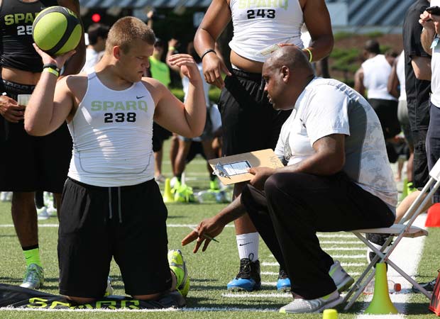 Lineman Brian Allen (left) of Hinsdale Central (Ill.) receives instructions before competing in the kneeing power ball toss during the preliminary round of the SPARQ Rating National Championships.