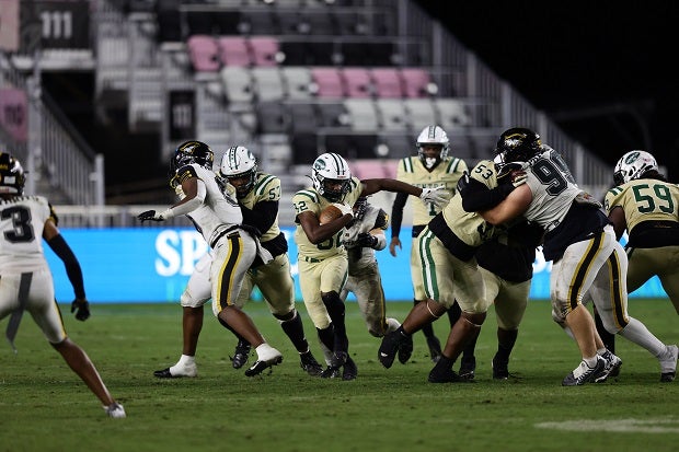 Miami Central's Jonathan Harris busts up the middle for a big-time TD run that gave the Rockets cushion in their 38-31 win over American Heritage in the Florida 2M finals. (Photo: Laura Martin)