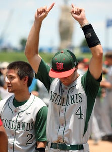 Charlie Warren (4) holds up hands
triumphantly during post-game
ceremonies at Dell Diamond.