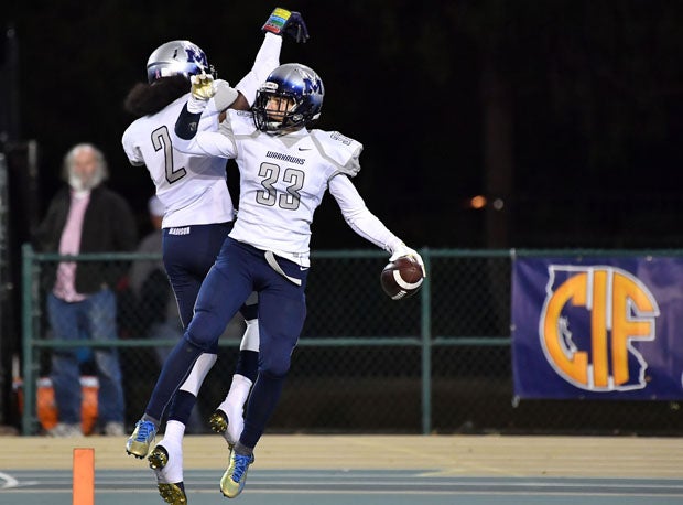 Roland White (2) and Brandon Lewis (33) celebrate for Madison.