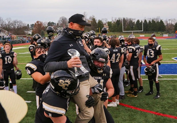 Southern Columbia Area players hoist coach Jim Roth after the Tigers' semifinal win on the way to a fourth straight AA state title. Southern Columbia Area finishes at the top team in the MaxPreps small school high school football rankings.