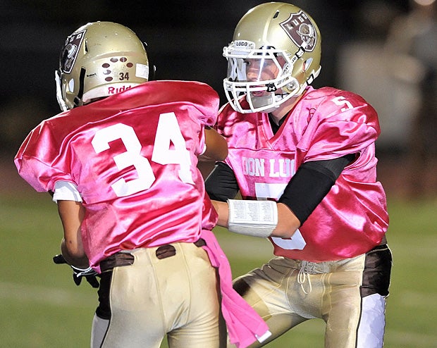 HS football teams showed support during pink October
