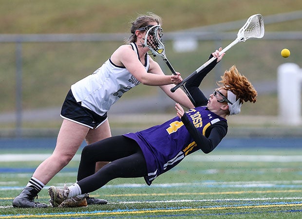 A Middletown South (N.J.) player (left) and a St. Rose player collide during a girls lacrosse game.