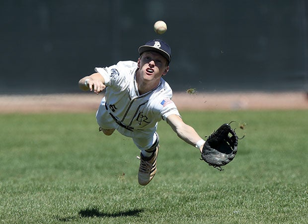 Pusch Ridge Christian Academy (Ariz.) center fielder Matt Weber dives for a catch during a game in the Lancer Classic.