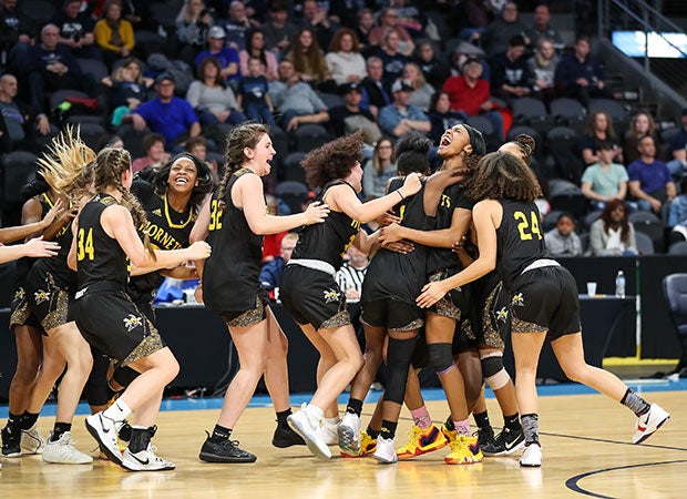 North Kansas City (Mo.) players rush the court to celebrate their victory in the MSHSAA Class 5 quarterfinal game against Lee's Summit West.
