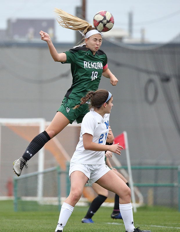 Eden Jones of Reagan (Texas) leaps for a header on a corner kick against MacArthur.