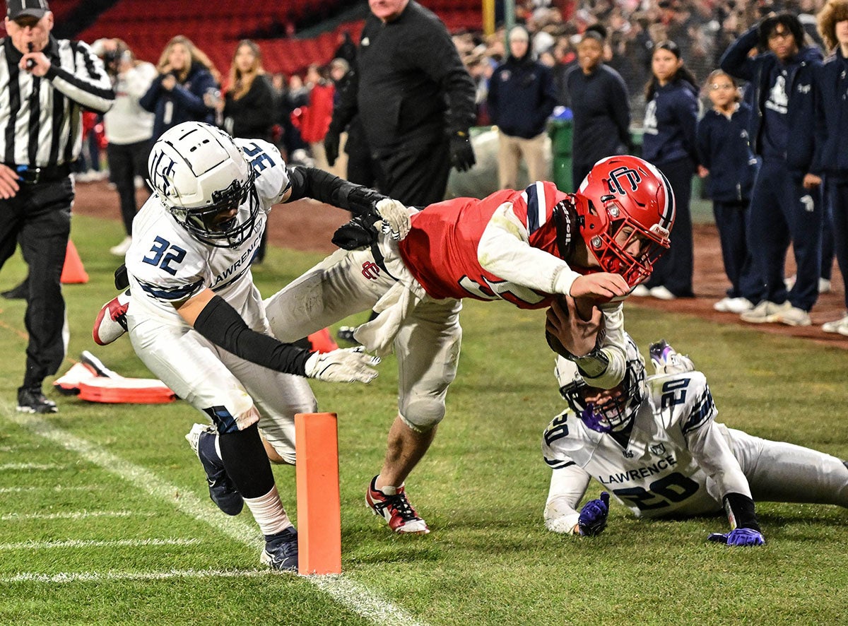 Central Catholic quarterback Caden Smith makes a dive toward the end zone at Fenway Park. The Raiders defeated Lawrence 34-12. (Photo: Mike Braca) 