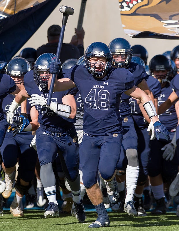 Palmer Ridge (Colo.) linebacker Colton Dill leads his teammates onto the field before the CHSAA 3A state title game against Erie.
