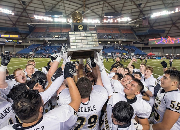 Royal (Wash.) players hoist the championship trophy following their victory over Meridian in the WIAA 1A state title game at the Tacoma Dome.