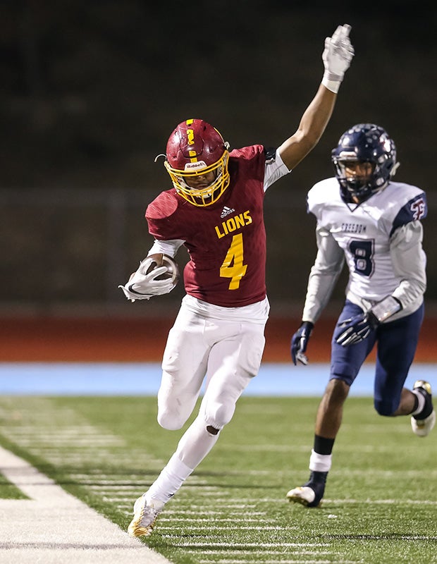Liberty (Calif.) running back Tyerell Sturges-Cofer tight ropes along the sideline while attempting to stay inbounds against Freedom in the CIF North Coast Section Division 1 title game.