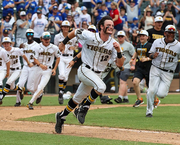 Riggin Smith of Malakoff (Texas) races to his teammate at first to celebrate the game-winning hit in the UIL 3A state championship game at Dell Diamond Stadium.