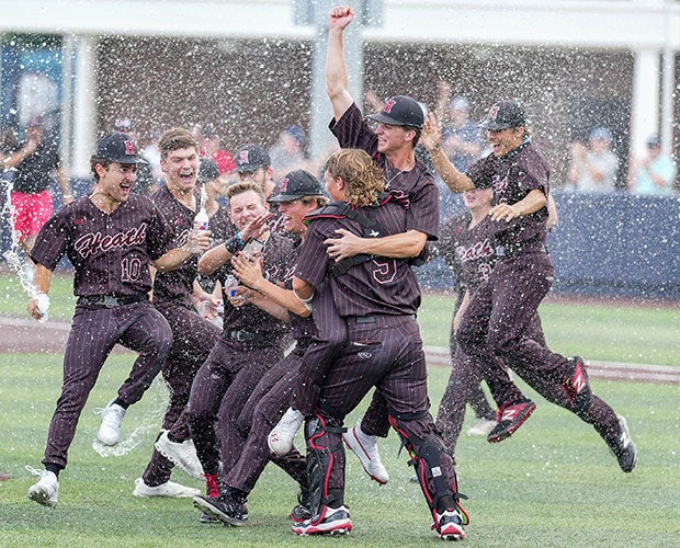 Rockwall-Heath (Texas) players celebrate with a water-bottle dousing after winning the UIL 6A Regional title game against crosstown rival Rockwall.