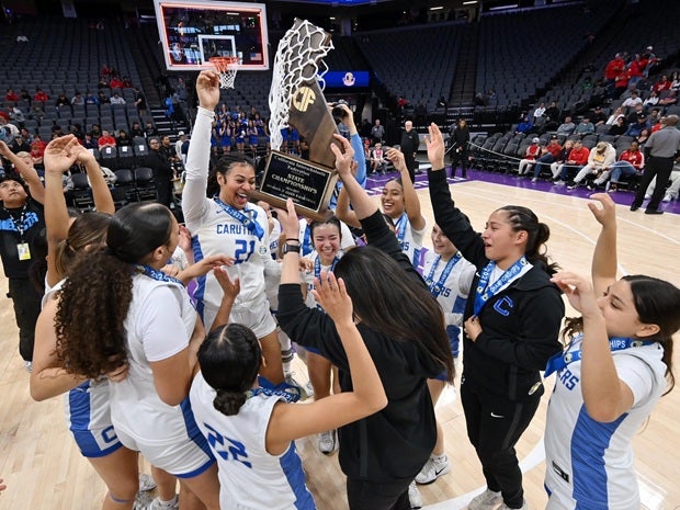 The Caruthers Blue Raiders celebrate their California Division II title on Saturday at Golden 1 Center in Sacramento. It was the second straight title for Caruthers after winning the Division III crown last season. (PHOTO: David Steutel)