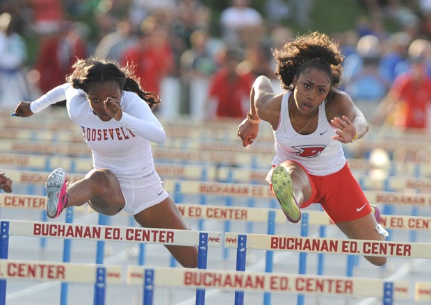 Roosevelt senior Jasmyne Graham (left) battles defending 100 hurdles champion Mecca McGlaston, of Dublin, in a remarkable 2015 championship showdown in the CIF State Championships at Buchanan High School in Clovis on Saturday.