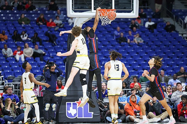 Duncanville junior Cameron Barnes throws down between a pair of McKinney defenders at the Alamodome.