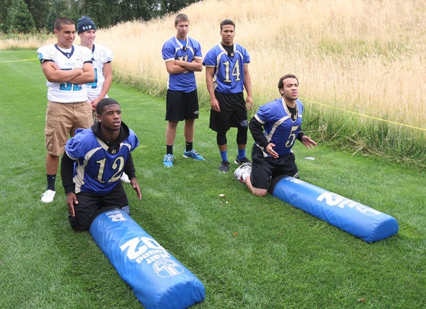 Players participate in a tackling drill during Sunday's media day event. 