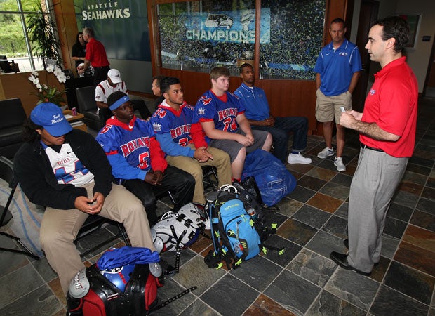 Garrett Shea (right), USA Football Senior Director of Sponsorships & National Teams, speaks to coaches and players from  Kent-Meridian High School. 