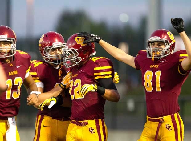 Central Catholic's Cameron Scarlett (22) is congratulated by teammates.
