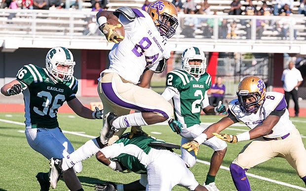 Charles Jones of St. Augustine (New Orleans) leaps over an Archbishop Shaw defender.