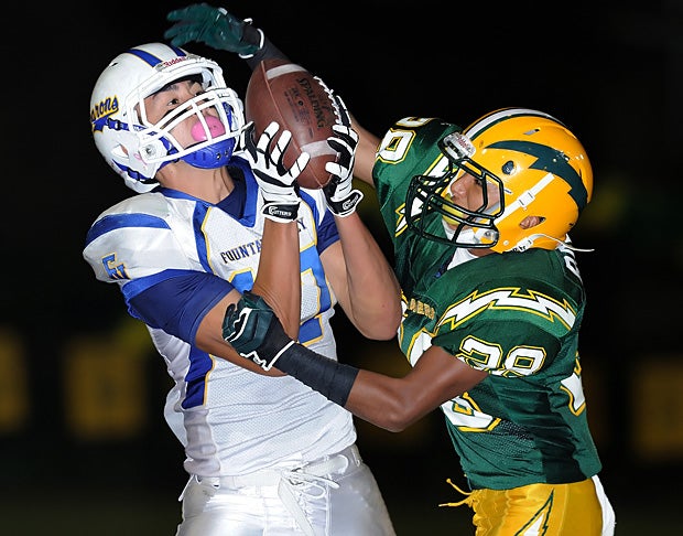 Anthony Arevalos of Fountain Valley (Calif.) hauls in a pass against a tough Edison (Huntington Beach, Calif.) defender.