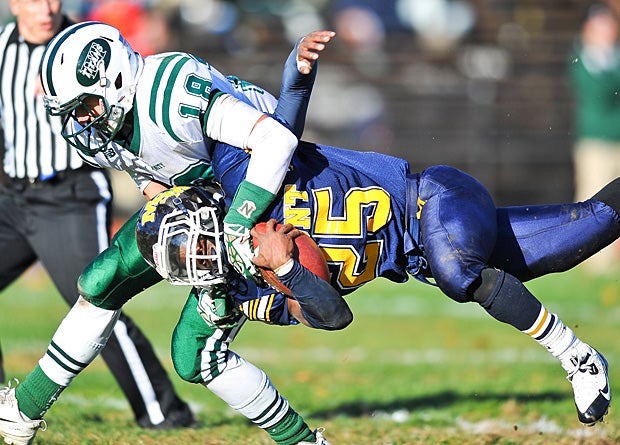 Mt. St. Michael Academy (Bronx, N.Y.) runner Aaron Brown goes horizontal after being tackled by a Holy Trinity (Hicksville, N.Y.) defender.