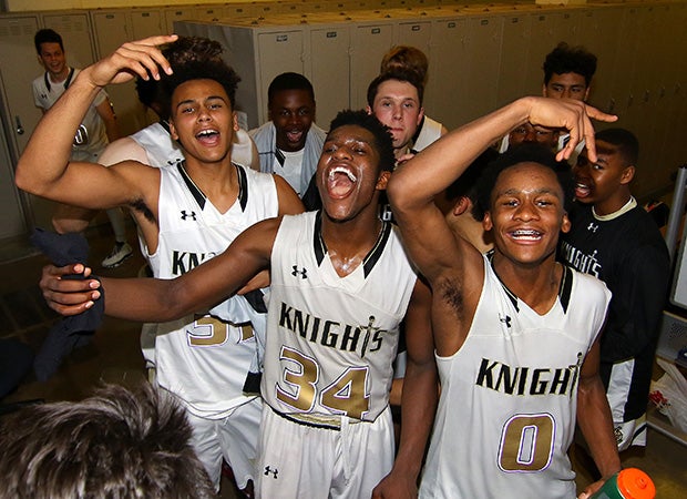 Guard David Singleton (center) leads his Bishop Montgomery teammates while celebrating in the locker room following their victory over Chino Hills on Tuesday night.