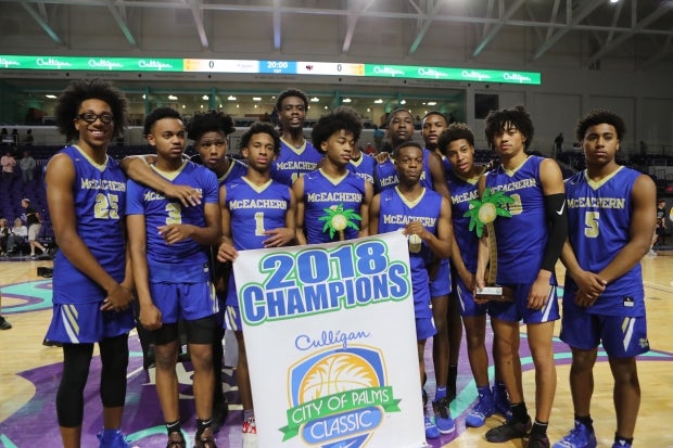 McEachern poses with the championship banner after winning the City of Palms Classic.