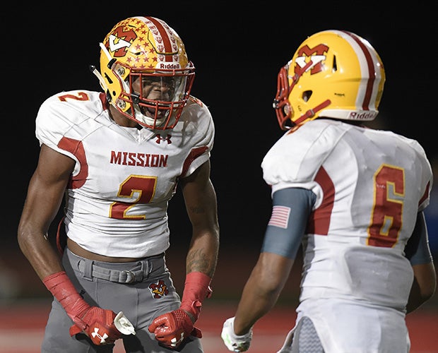 Mission Viejo cornerback Olaijah Griffin celebrates with teammate Akili Arnold after scoring on an interception return in the fourth quarter.