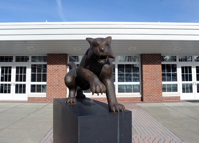 The Hotchkiss Bearcat stands ready outside the Mars Athletic Center wing that houses the facility's two hockey rinks.