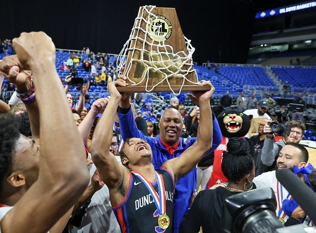 Duncanville's C.J. Ford hoists the UIL 6A trophy after the Panthers' 69-49 title win over McKinney on Saturday.