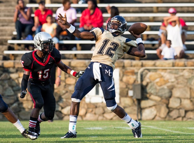 Mallard Creek quarterback Emiere Scaife is rushed hard by Butler's Todjrei Graham in an early game last season. Both teams figure to battle it out for a North Carolina state title.