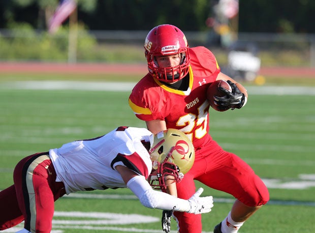 Cathedral Catholic running back Adam Eastwood hit hard by an Oaks Christian defender. 
