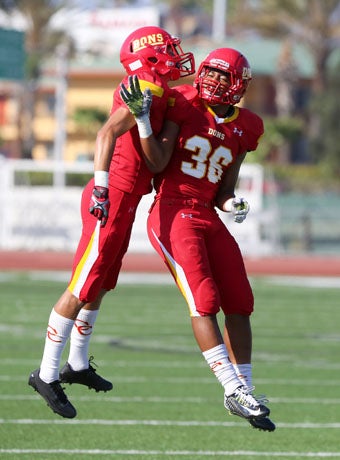 Currie Thomason (36) leaps for joy with a teammate
after scoring one of his two touchdowns. 