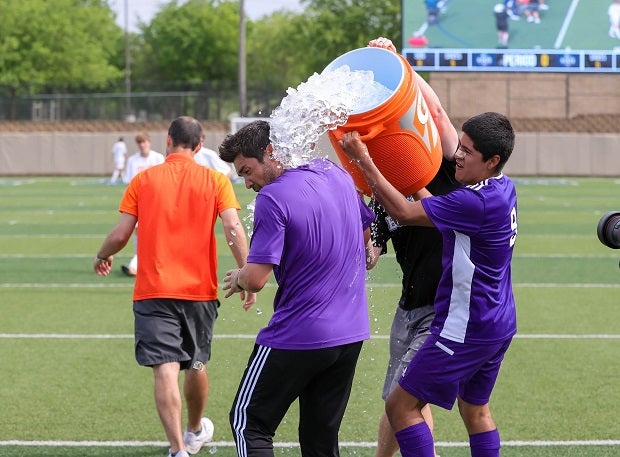 Boerne (Texas) head coach Michael Strong is on the receiving end of an ice bath after the Greyhounds won their second consecutive UIL 4A state title, beating Celina 2-1.