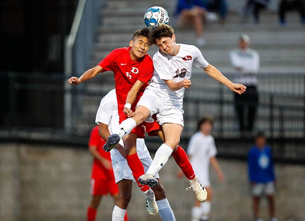 A Dalton (left) and a Johns Creek (Ga.) player collide while battling for a header in the GHSA 6A championship game.