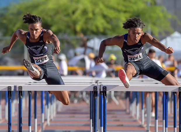 Valley Vista (Ariz.) senior twins Tyson (left) and Trenton Givens are in sync while competing in the finals of the 110 meter hurdles at the AIA Track and Field championships. Trenton won the race while his brother finished a close second. 
