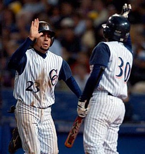 Chatsworth's Willie Cabrera receives a high five
from teammate Oliver Padre.