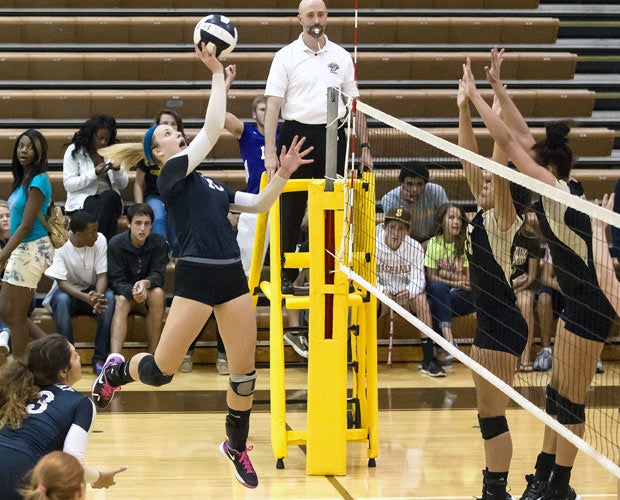 McHenry looks to tip over the block during a match against visiting Warren Central on Oct. 2.