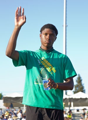 Castro Valley's Nate Moore waving on the podium
after winning the state long jump title in 2013.