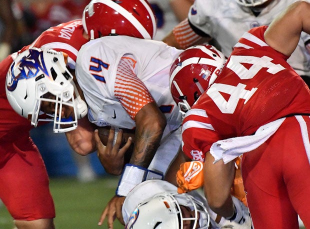 Mater Dei harrassed Dorian Thompson-Robinson all night, including Steele Dubar (44) on this play.