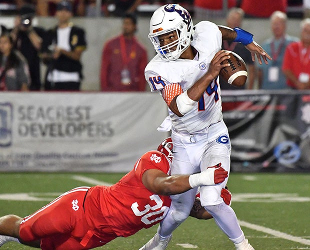 Mater Dei linebacker Nathan Logoleo takes down Bishop Gorman quarterback Dorian Thompson-Robinson.