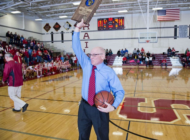 Al Guthman, the winningest girls basketball coach in Wisconsin history, holds up a state sectional plaque. Retiring this year, Guthman is seeking his first state title.  