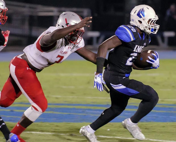 IMG Academy running back Asa Martin attempts to elude a St. John's defender.