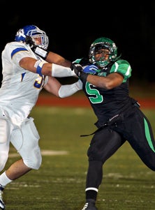 Upland defensive lineman Joe Mathis
leads his team against Rancho
Cucamonga on Friday.