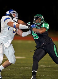 Upland defensive lineman Joe Mathis
leads his team against Rancho 
Cucamonga on Friday. 