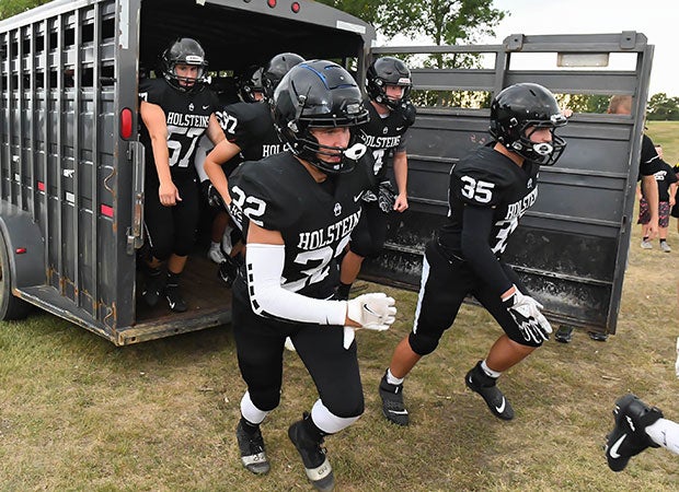 New Salem/Glen Ullin players break out of a cattle truck before their Aug. 27 game against host Standing Rock/Selfridge in North Dakota.
