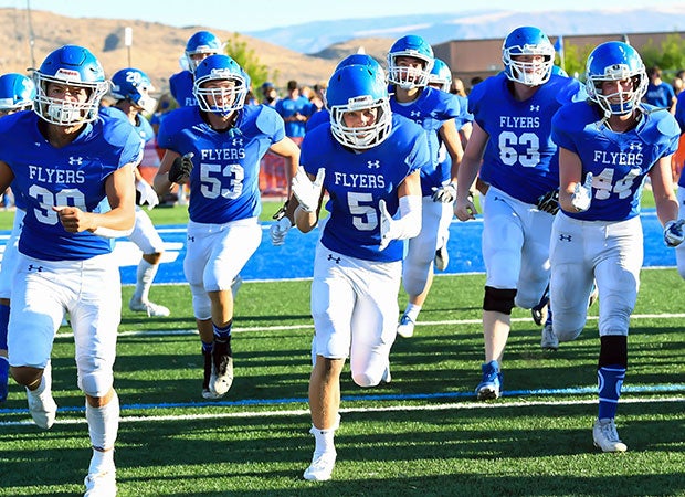 Dixie players rush onto the field before the kickoff of their season opener in Utah on Aug. 14.