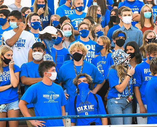 Dixie students look on while wearing face masks during their home opener.